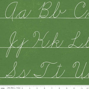 May include: A green chalkboard with white cursive letters of the alphabet. The letters are written in rows, with each row containing three letters. The letters are "Aa Bb C", "Jj Kk Ll", and "Ss Tt U".