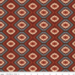May include: A repeating pattern of diamond shapes in shades of red, beige, and blue. The design has a geometric, Southwestern style, with each diamond composed of smaller, stepped shapes. The pattern is printed on a fabric, with the text "Riley Blake Designs" at the bottom.