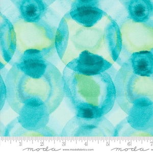 May include: Abstract watercolor fabric with a teal and green color scheme. The fabric features a repeating pattern of overlapping circles.