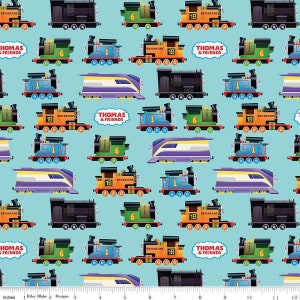 May include: A blue fabric with a repeating pattern of colorful toy trains. The trains are in various styles and colors, including blue, green, orange, and red. The fabric features the text "Thomas & Friends".