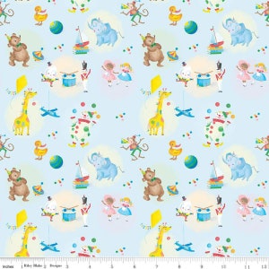 May include: A light blue fabric with a repeating pattern of whimsical circus and toy illustrations. The design includes giraffes, elephants, bears, clowns, and toy soldiers. The fabric has a playful and colorful aesthetic, with a ruler at the bottom showing inches.