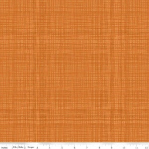 May include: Orange fabric with a woven texture. The fabric has a subtle, light brown pattern.