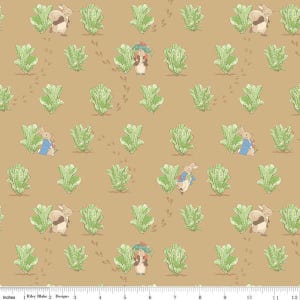 May include: A repeating pattern featuring illustrations of rabbits in blue jackets and other small animals, interspersed with green lettuce plants and footprints, set against a tan background. The design includes the text "Riley Blake Designs" and inch measurements.