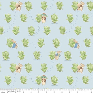 May include: A light blue fabric featuring a repeating pattern of rabbits, lettuce, and footprints. The rabbits are depicted in various poses, wearing blue jackets and hats. The lettuce is green, and the footprints are light gray. The fabric is marked with inches.