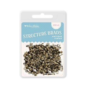 May include: A package of 100 antique finish structure brads. The brads are a bronze color and are in a clear plastic package with a blue and white label. The label reads "Structure Brads" and "Riley Blake Designs."