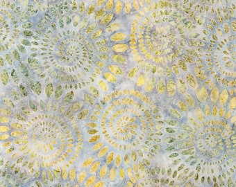 May include: Fabric with a repeating pattern of spiraling floral designs in shades of yellow, green, and blue. The fabric has a mottled appearance, with a light blue background and a ruler along the bottom edge.