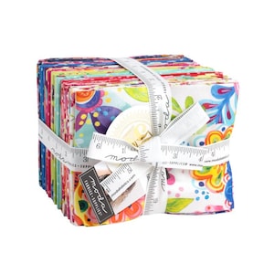 May include: A stack of colorful fabric squares with a white background and floral patterns. The fabric is tied together with a white ribbon and a measuring tape that reads "moda fabrics".
