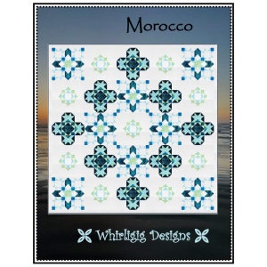 May include: A quilt pattern called "Morocco" featuring a geometric design in shades of blue, green, and white. The pattern is surrounded by a white border and the text "Whirligig Designs" is at the bottom.