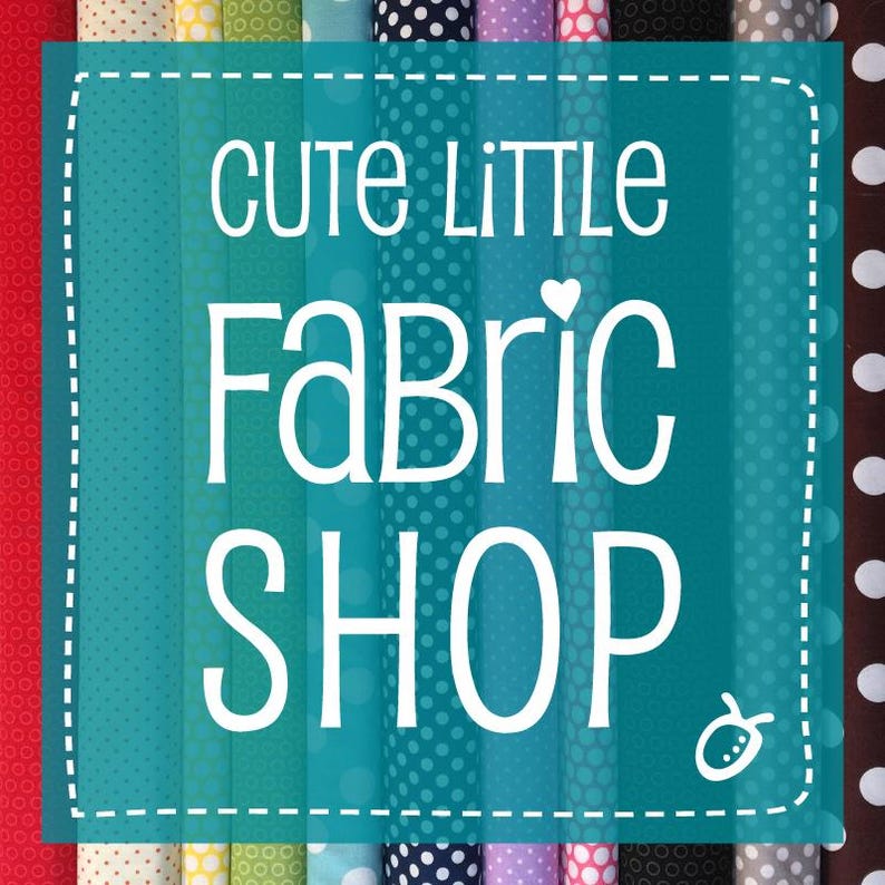 May include: A teal blue sign with white text that reads "Cute Little Fabric Shop" with a small white heart and a white bug illustration. The sign is surrounded by rows of colorful fabric with white polka dots.