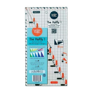 May include: A clear, rectangular quilting ruler with grid lines and measurements. The ruler features the text "The HuRTy 1" and "Latifah Saafir." It includes cutting and sewing directions for half rectangle triangles. The ruler has measurements in inches.