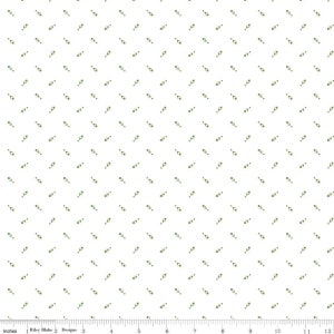 May include: White fabric with a repeating pattern of small green sprigs. The sprigs are arranged in a diagonal pattern.