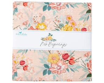 May include: A pink fabric with a floral pattern featuring pink, yellow, and green flowers. The fabric has a white label with the text "Riley Blake Designs" and "New Beginnings".