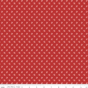 May include: Red fabric with a white repeating pattern of small four-leaf clovers.