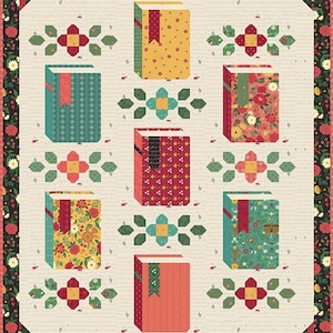 May include: A rectangular quilt featuring a cream background with a faint script pattern and a dark floral border. The design includes five book-shaped blocks in yellow, teal, red, and coral, interspersed with small green and red floral motifs.