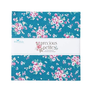 May include: A stack of fabric squares with a teal background and a floral pattern in pink, white, and yellow. The fabric is labeled "precious petites" by Gemi Robinson of Planted Seed Designs.