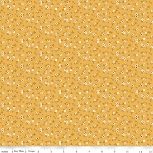 May include: A yellow fabric with a repeating pattern of small white flowers with red centers. The fabric is a quilting cotton and is perfect for crafting projects.