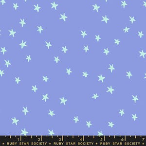 May include: A purple fabric with a repeating pattern of light blue stars. The fabric has a ruler with markings in inches.