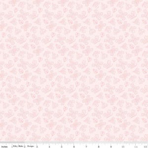 May include: A light pink fabric featuring a repeating pattern of white line-art butterflies and ladybugs. A white ruler with black markings is visible at the bottom, showing a scale of 12 inches for the width of the textile design.