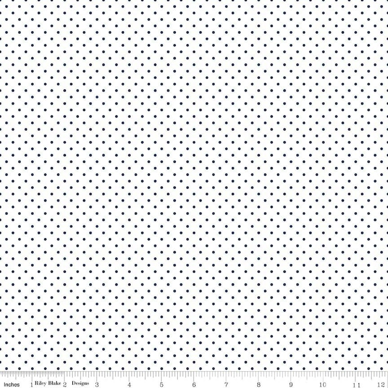 May include: White fabric with a repeating pattern of small, dark blue polka dots.