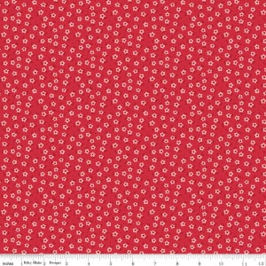 May include: Red fabric with a white floral pattern. The fabric is covered in small white flowers.