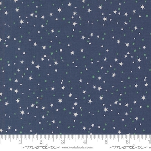 May include: Navy blue fabric with a scattered pattern of white stars and small green and white dots. The fabric has a textured appearance and is suitable for quilting or other craft projects. The image includes a ruler along the bottom edge.