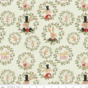 May include: A cream-colored fabric with a repeating pattern of bunnies wearing top hats and bow ties. The bunnies are surrounded by wreaths of green leaves and pink flowers. The fabric has the words "Bunny" printed on it.