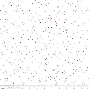 May include: White fabric with a scattered pattern of small red, blue, and black squares.