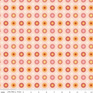 May include: A fabric with a repeating pattern of stylized flowers in shades of pink, orange, and yellow on a light pink background. The flowers are arranged in a grid-like pattern. The fabric is measured in inches.