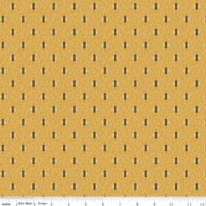 May include: Mustard yellow fabric with a repeating pattern of small, dark gray rectangles and light beige accents. The fabric has a textured, dotted background and is marked with inch measurements along the bottom.