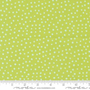 May include: A green fabric with a white polka dot pattern. The fabric is measured in inches.