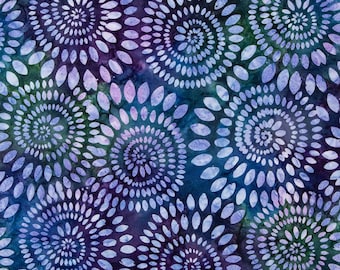 May include: Fabric with a repeating pattern of spiraling, oval-shaped designs in shades of blue, purple, and white. The fabric has a batik-like appearance with a dark blue and green background. The text "Riley Blake Designs" is visible at the bottom.