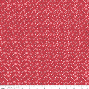 May include: Red fabric with a white repeating pattern of interlocking circles and dots.