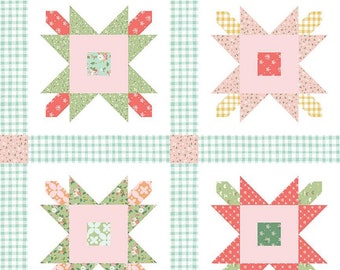May include: Four quilt blocks with a star design in the center. The blocks are made of pink, green, red, and yellow fabric with floral patterns. The blocks are set against a white background with a green and white gingham pattern.
