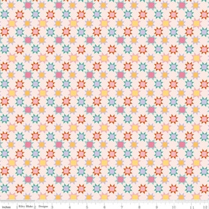 May include: A repeating pattern of colorful starbursts in shades of pink, yellow, orange, teal, and purple on a light pink background. The fabric is marked with inch measurements along the bottom. The text "Riley Blake Designs" is visible.