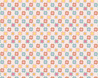 May include: A repeating pattern of colorful starbursts in shades of pink, yellow, orange, teal, and purple on a light pink background. The fabric is marked with inch measurements along the bottom. The text "Riley Blake Designs" is visible.
