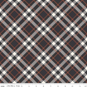 May include: Black and white plaid fabric with thin orange stripes. The fabric is shown on a ruler with inches marked.