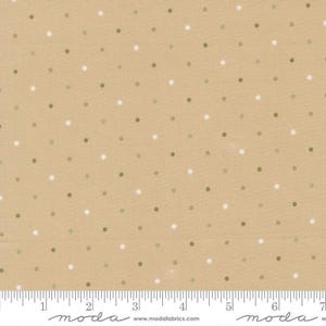 May include: A tan fabric featuring a repeating pattern of small, evenly spaced white and sage green polka dots. A white ruler is visible at the bottom edge, showing measurements in inches from 0 to 7, with the text moda and modafabrics.com.