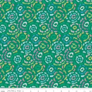 May include: Green fabric with a repeating pattern of spiral designs. Each spiral is composed of colorful, scribbled lines in shades of white, pink, yellow, and blue. The fabric has a ruler along the bottom edge with the text "Riley Blake Designs".
