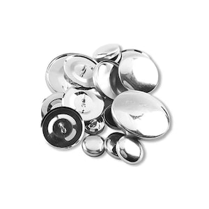 May include: A collection of shiny, silver-colored buttons of various sizes. The buttons have a smooth, reflective surface and a circular shape. Some buttons have a visible shank on the back for sewing. The buttons are scattered against a white background.