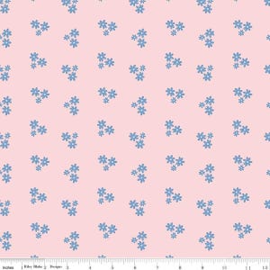 May include: A fabric with a repeating pattern of small blue flowers on a light pink background. The flowers are clustered in small groups, creating a delicate and feminine design. The fabric is measured in inches.