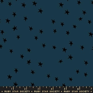 May include: A dark blue fabric with a repeating pattern of black stars. The fabric is printed with the text "RUBY STAR SOCIETY" in gold.