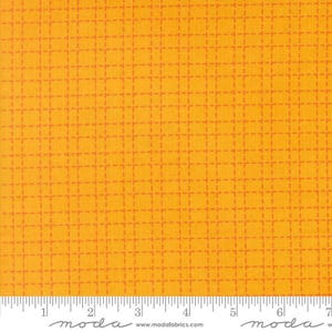 May include: A bright yellow fabric featuring a repeating grid pattern of thin, dashed orange lines. The bottom edge displays a white ruler with black markings and the text "moda" and "www.modafabrics.com" printed clearly.
