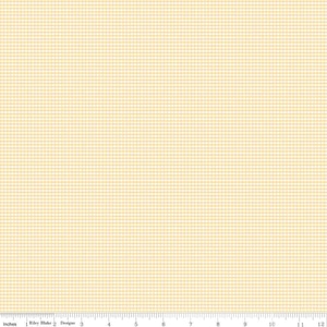 May include: A pale yellow fabric with a fine white gingham pattern. The fabric is shown with a ruler in inches.