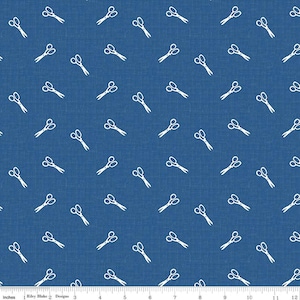 May include: Blue fabric with a repeating pattern of white scissors. The scissors are drawn in a simple, outline style. The fabric has a textured appearance, and the scissors are scattered across the surface.