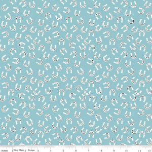 May include: A light blue fabric with a white horseshoe pattern. The horseshoes are scattered randomly across the fabric.