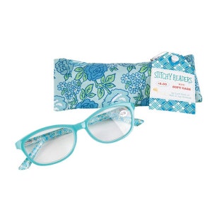 May include: Blue reading glasses with a floral print case. The glasses have a +2.50 magnification. The case has a tag that says "Stitchy Readers with Soft Case by Lars Holt of Bee is my Bonnet".