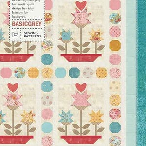 May include: A quilt pattern featuring a floral design with the text "Love Grows" and "Pat 078". The pattern includes a variety of colors, including pink, red, yellow, blue, and green. The text "Basicgrey" and "Sewing Patterns" is also included.