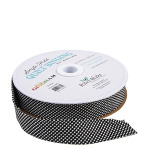 May include: A spool of black and white gingham single-fold quilt binding tape. The label reads "Single Fold Quilt Binding" and "2 1/4" Bias Tape". The tape is made of 100% cotton and is from Riley Blake Designs.