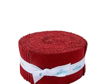 May include: A roll of red fabric strips, tightly wound and secured with a white ribbon. The ribbon is printed with the text "Riley Blake Designs". The fabric appears to be textured, and the overall presentation is neat and compact.