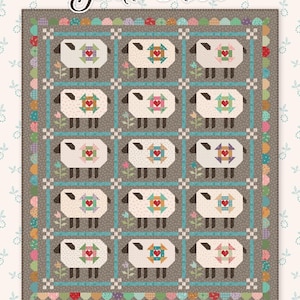 May include: A patchwork quilt with a gray background featuring a repeating pattern of sheep with heart-shaped designs. The quilt has a teal border and is adorned with the text "Gentle Flock" and the designer's name.